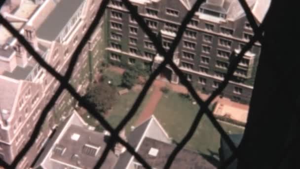 バルコニーのネットフェンスを通ってアーチ型の入り口と芝生と古い歴史的な建物の空中ビュー 1965年のヴィンテージ映像 — ストック動画
