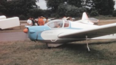 Vintage motor glider in a country airclub begins taxiing toward takeoff. Slingsby T.61A Falke or Venture G-AYYK a license built version of the Scheibe SF 25B side-by-side two-seat monoplane motor