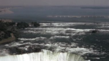 Powerful cascading waters and stunning panoramic view of Niagara Falls. A breathtaking natural wonder located on the border of New York and Canada. Old stock footage of the 1960s. Concepts of awe