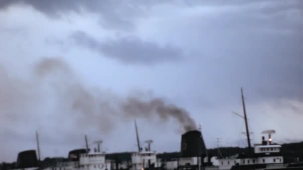 ニューヨーク州ナイアガラの滝の近くの工業地帯のパノラマ映像 煙は曇った空に対する港湾施設の煙突から立ち上がる 1965年のヴィンテージ映像 環境大気汚染の概念 — ストック動画