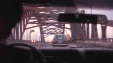 1970 'lerde Brooklyn Köprüsü' nde araba süren adam el kamerasıyla çekilen POV bakış açısıyla görülüyor. Güneşli bir günde New York 'un tarihi görüntüleri.