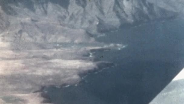 上からグラン カナリア砂漠の海岸線の空中ビュー 1950年代の懐かしい映像 大西洋とブラウンドライカナリア諸島山脈の青い水 レトロ航空会社のメタルウィング — ストック動画