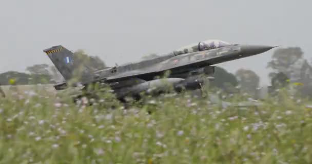 希腊空军2座F 16战斗机在暴雨中着陆 人们看到喷气式飞机接近跑道 放慢速度 在水中着陆 恶劣天气下军用喷气式飞机着陆 — 图库视频影像