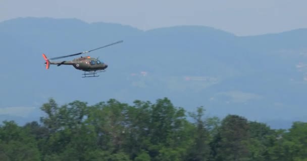 2023年6月4日 高速观测军用直升机在树梢上方进行大回旋机动 显示出机敏和速度 — 图库视频影像