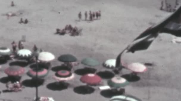 People Enjoy Summer Beach Surrounded Umbrellas Sunshine Flag Waves High — Stock Video