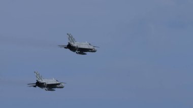 Pula Croatia March 23 2024: Pair of mikoyan-gurevich mig-21 fishbed jet fighters from the croatian air force flying with sky backdrop and copy space clipart