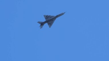 Pula Croatia March 23 2024: A mig-21 fishbed jet from the croatian air force soaring in a clear blue sky, with copy space clipart