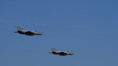 Pula Croatia March 23 2024: Pair of mikoyan gurevich MiG-21 fishbed fighter jets from the croatian air force soaring in a clear blue sky. Copy space. clipart