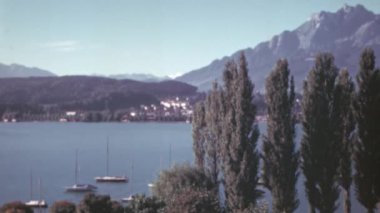 Arka planda Rigi Dağı ve Lucerne Gölü 'nün panoramik manzarası. 1950' lerin güneşli bir gününde tekneler ön planda demirli. Renk 4K arşiv görüntüleri.