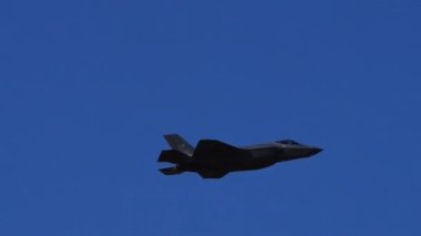 Atina Yunanistan 3 Eylül 2023: Modern Amerikan savaş jeti, art brülör alevi tamamen görünür bir şekilde açık mavi gökyüzüne dikey olarak tırmanıyor. Lockheed Martin F-35 USAF Şimşek II. 