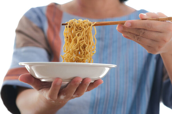 Closeup shot of a woman eating Chinese fried noodle using chopsticks