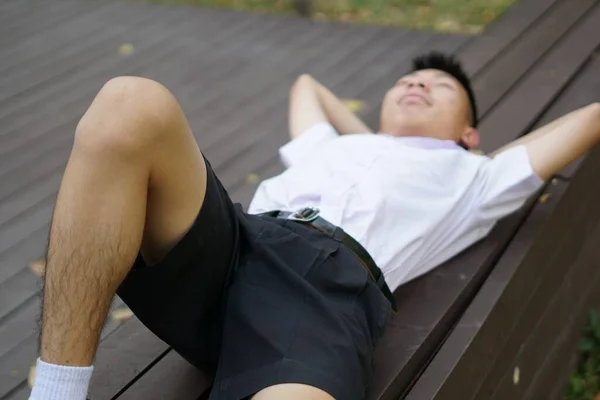 Young Man Lying Bench Park — Zdjęcie stockowe