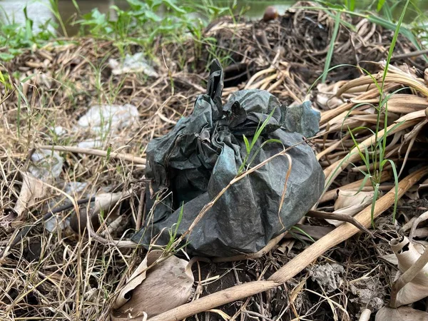 garbage bag, trash in the forest.