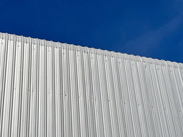 White roof of a building with blue sky background
