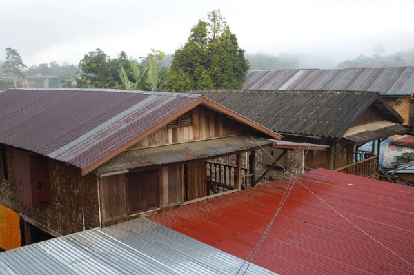 stock image wooden roof with a red and white clouds