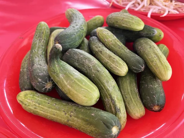 Fresh Cucumbers Red Background — Stockfoto