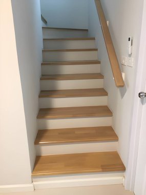 Duvarında merdiven olan boş beyaz ahşap merdiven.