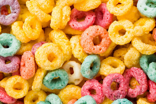 colorful tasty cereal as background, top view