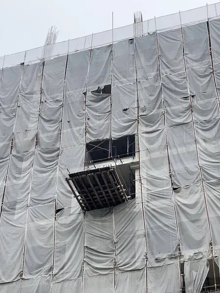 Bina inşaat halinde. İskele ve beton duvar