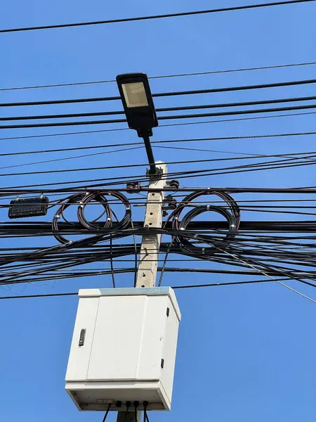 light pole with electric box near street in Thailand