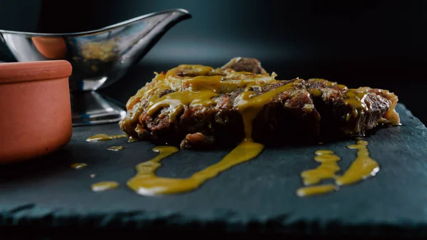 Veal osso buco with sauce presented on a slate plate. Foodie. close-up. selective focus.