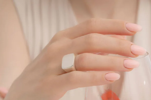 stock image Woman showcases jewelry with a glass of pink drinks. Part images for e-commerce, social media, product sales.