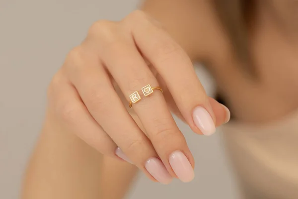 Jewelry on the girl\'s hand with soft nail polish. Extraordinary Woman jewelry concept. Jewelry image for e-commerce, online sale, social media.