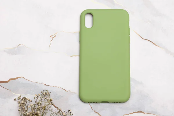 stock image Colorful phone case on a marble look floor. E-commerce product image.