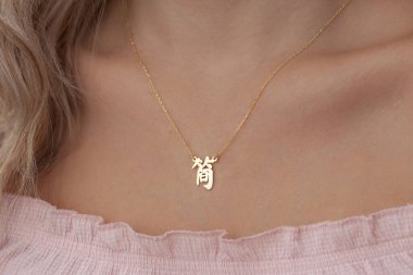 Bakımlı bayan renkli elbisesiyle özel mücevherlerini sergiliyor. E-ticaret satışları için modellenmiş mücevher fotoğrafı.