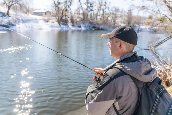 Fisherman Fishing Rod Backpack Catches Fish Bank Snow Covered River — Stock Photo, Image