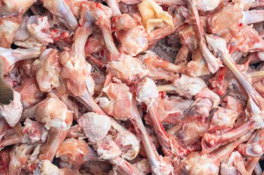 Raw chicken bones, production leftovers. Background texture. clipart