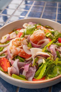 Yakın çekim, Baharatlı deniz ürünleri salatası mavi fayanslı yüzey, Tayland yemeği