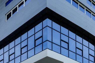 Mavi gökyüzü ve bulutlar modern ofis binası Windows'da yansıyan