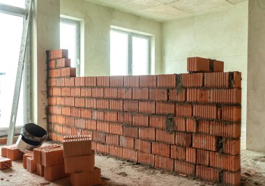 Çok katlı bir evin duvarları arasında kırmızı tuğladan yapılmış bir mason.