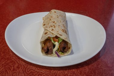 Middle East dishe culinary Still Life. Seek Chicken fillet wrap with vegetable and salad