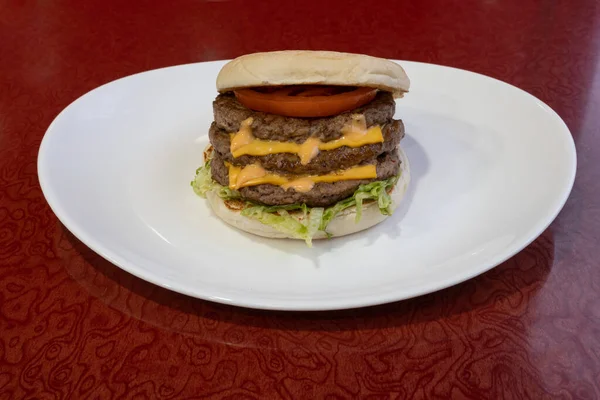 Middle East dishe culinary Still Life. Triple Cheese burger with chopped steak, cheddar cheese, vegetable and salad