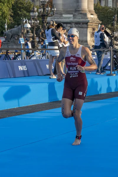 stock image Paris, France - 08 17 2023: Paris 2024 triathlon test event. Parade of female triathletes at the start of the race from the Alexandre III bridge