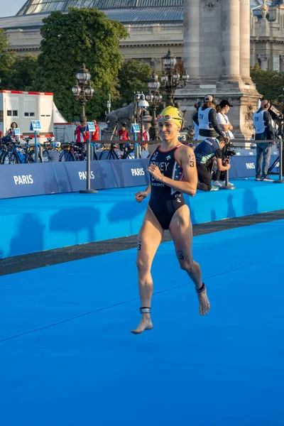 stock image Paris, France - 08 17 2023: Paris 2024 triathlon test event. Parade of female triathletes at the start of the race from the Alexandre III bridge