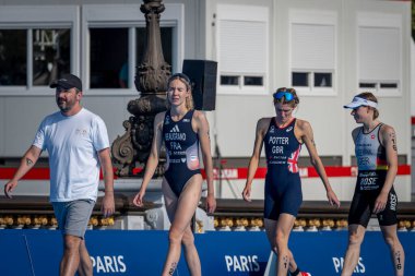 Paris, France - 08 17 2023: Paris 2024 triathlon test event. Female athletes winner are walking to to get their medal clipart