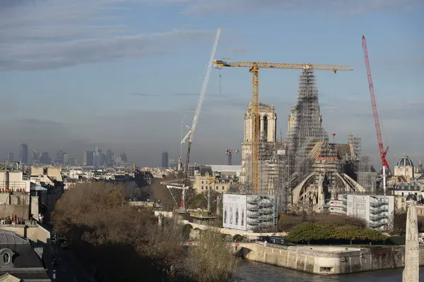 stock image Paris, France - 11 30 2023: Notre Dame de Paris. Panoramic view of the renovation site with scaffolding and the new steeple from Arab World Institute