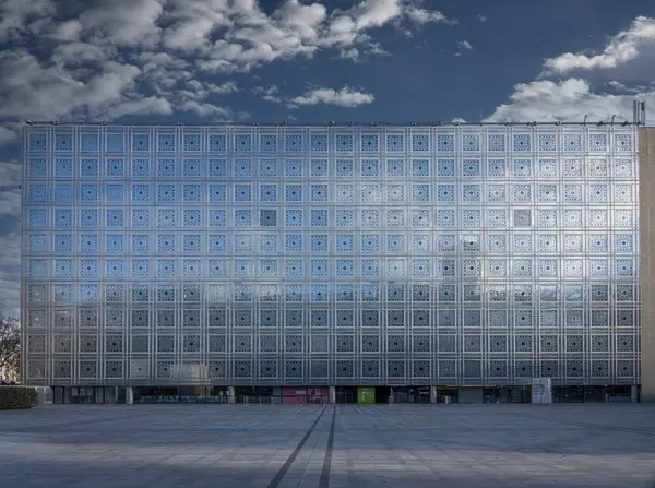 stock image Paris, France - 11 30 2023: Arab World Institute. View of the reflective facade of the building with a blue sky with clouds