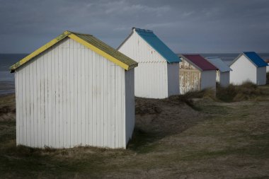 Kum tepelerindeki Gouville 'in renkli banyo yapan ahşap kulübelerinin manzarası.