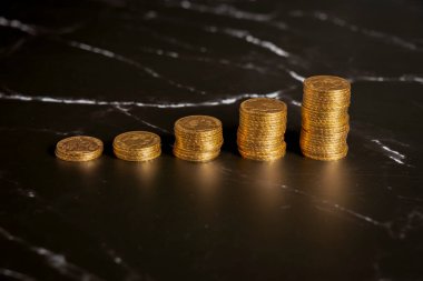 Durgun hayat. Siyah ve beyaz mermer bir yüzey üzerinde altın Louis sikkeleri yakın çekim yığını