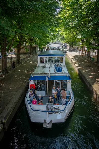 Stock image Paris, France - 05 25 2024: Canal Saint-Martin. View of a touristic boat in the canal basin