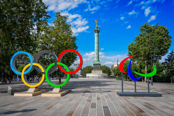 Paris, France - 07 20 2024: Olympic Games Paris 2024. View of the Bastille's Place with the July Column, the Paralympic Flames and the Olympic Rings
