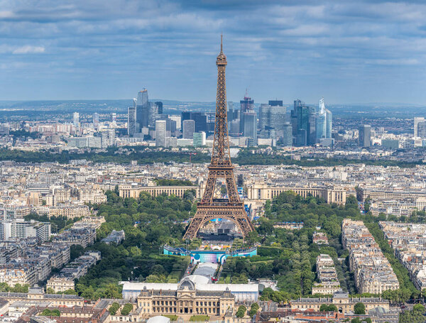 Paris, France - 07 22 2024: Olympic Games Paris 2024. View of Champ-De-Mars Arena, the Olympic site facilities for Beach Volleyball, the Eiffel Tower and La Defense District from Montparnasse Tower