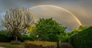 Alencon, France - 08 09 2024: View of a colorful rainbow in the Normandy countryside clipart