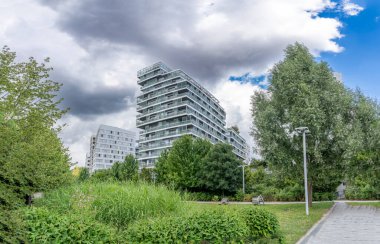 Paris, France - 07 20 2024: Clichy-Batignolles Martin Luther King Park. View of a buildings around the park clipart