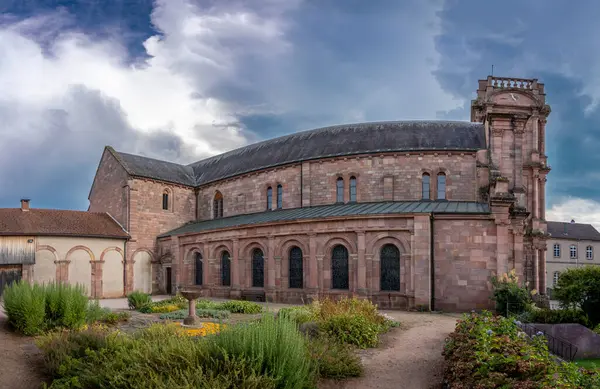 stock image Etival-Clairefontaine, France - 09 01 2024: Saint-Pierre Abbey. Panoramic view outside of the facade of the abbey and garden from the side