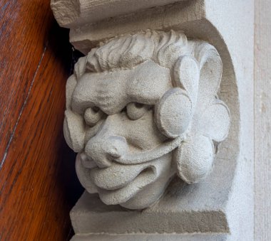 Bernardswiller, France - 09 02 2024: Church of Bernardswiller. View of a devil head sculpture on a door of the church clipart